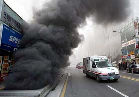 Ambulance passes by an air escape near a subway station in Taegu