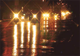 Vehicles flash lights after squall hit the city on Wednesday