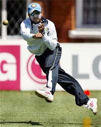 India�s Virender Sehwag throws the ball during a team practice session