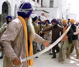 An activist of the Shiromani Khalsa Panchayat brandishes sword