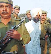 Ranjit Singh Gill, sentenced to life imprisonment, being taken away by the police in the Capital