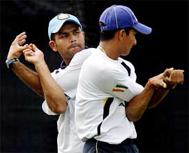 Virender Sehwag and Sanjay Bangar perform warm-up exercises
