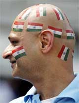 An Indian fan with national colours painted on his face watches India's match against England