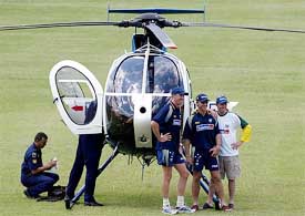 Australia's Glenn McGrath, Andy Bichel and Ian Harvey pose next to a police helicopter 