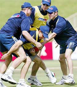 Australia's Brad Hogg is wrapped up by teammates Matthew Hayden, Glenn McGrath and Damien Martyn in a game of touch-footy