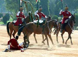 One of the President�s bodyguards tumbles from the horse
