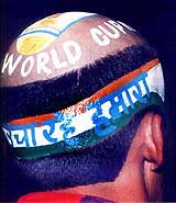 A cricket fan with tonsured head, featuring World Cup slogans