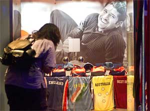 A young girl looks at t-shirts of teams participating in the cricket World Cup 