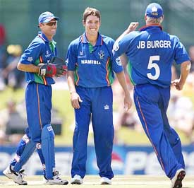 Namibian bowler Louis Burger is congratulated by teammates