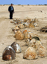 An Iraqi bystander looks at the remains of Iraqi missile heads