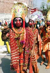 Devotees dressed as 'Hanuman' dance on the eve of Shivratri