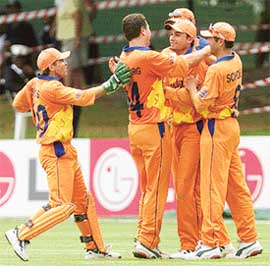 Dutch bowler Jan Feiko Kloppenburg embraces teammate Bas Zuiderent 