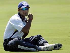 Indian captain Saurav Ganguly tucks in his religious beads during a practice session