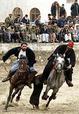 Afghan riders battle to grab the carcass of a headless goat during a game of "Buzkashi"