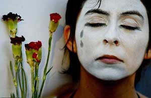Chilean peace activist holds flowers during a protest