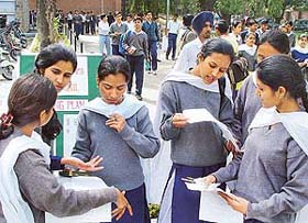 Students discuss physics paper on the first day of the CBSE plus two examination at Government Senior Secondary School, Sector 18, Chandigarh