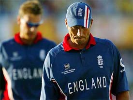 England captain Nasser Hussain and teammate Ashley Giles walk back despondently after their loss