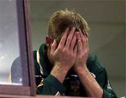 South African captain Shaun Pollock holds his head in his hands