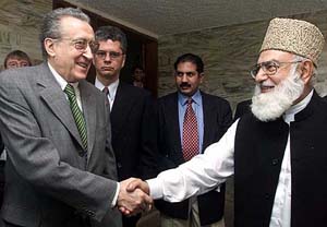 Kazi Hussein Ahmed, leader of the Muttahida Majlis-e-Amal (MMA), an alliance of six hardline Islamic parties, greets Lakhdar Brahimi, UN special envoy for Afghanistan