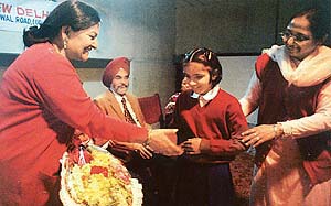 A visually-challenged student offers a bouquet to Ms Rupan Deol Bajaj