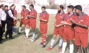 BSF Commandant S.C. Negi, along with Delhi Soccer Association secretary N.K. Bhatia, meet the players