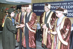A student being awarded a diploma at a convocation ceremony 
