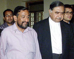 Bangladeshi journalist Enamul Haque Chowdhury, a part-time Reuters reporter, walks with his attorney