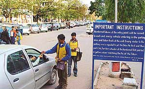 A parking contractor issues tokens for assured parking space to visitors in Chandigarh