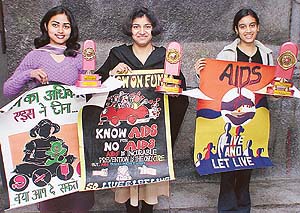 From right to left: Pallavi Bagga (1st), Kavita Singh (2nd), and Gayatri (3rd), winners of the regional-level poster-making competition, display their posters at Gandhi Bhavan, Panjab University, Chandigarh