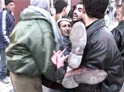 Reuters photographer Ahmed Jadallah is carried away after he was injured in the Jabalya refugee camp 