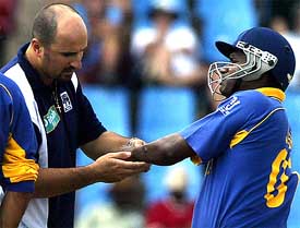 Sri Lankan captain Sanath Jayasuriya being helped off the field by the team trainer