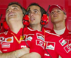 Germany's Michael Schumacher looks on with his Ferrari teammates