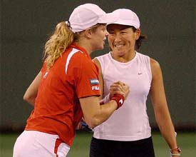 Ai Sugiyama of Japan shake hands with team-mate Kim Clijsters of Belgium after defeating Angelika Roesch and Martina Muller 6-4, 6-0 