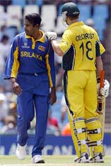 Australia's Adam Gilchrist pats Sri Lanka's Chaminda Vaas on the shoulder 