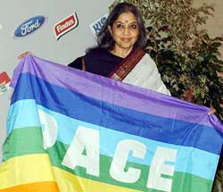 Tara Gandhi, niece of Mahatma Gandhi, holds a peace flag