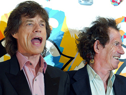 Rolling Stones lead singer Mick Jagger speaks with guitarist Keith Richards before a news conference in Tokyo 