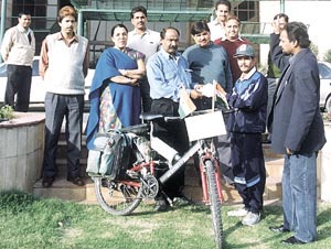 Cyclist Bhau Saheb Bhawar being given gifts by Indian Oil chief manager