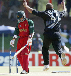 New Zealand's bowler Andre Adams celebrates bowling out Zimbabwean batsman Dion Ebrahim 