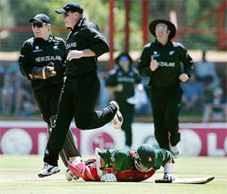 New Zealand�s Scott Styris jumps over Zimbabwe�s Andy Flower