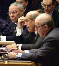 US Secretary of State Colin Powell and chief UN weapons inspector Hans Blix listen as chief atomic energy inspector Mohamed ElBaradei delivers a report 