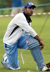India's Yuvraj Singh puts on his pad during a practice session 