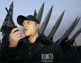 A South Korean policeman talks on a walkie-talkie