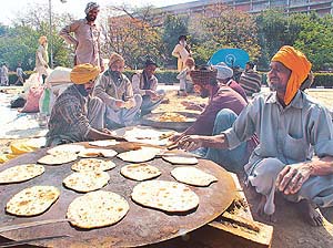 Farmers preparing a community lunch near Matka Chowk in Chandigarh, where they had put up tents to hold an indefinite dharna against �anti-farmer� policies of the state and Central governments.