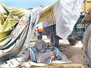 After participating in a protest march and dharna, farmers take rest near Matka Chowk on Tuesday.