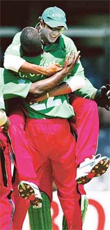 Kenya�s Ravindu Shah jumps into the arms of team-mate Collins Obuya