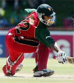 Bails fly past Zimbabwe's Dion Ebrahim's face after he was stumped for 13 by Kenyan wicket-keeper Kennedy Otieno