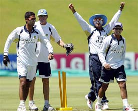 India's Virender Sehwag throws up his arms as team-mates Mohammad Kaif, Parthiv Patel and coach John Wright look on 