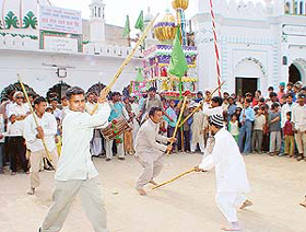 Devotees perform gatka during the Taazia procession taken out to mark Muharram in Chandigarh on Friday.