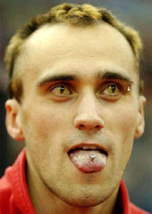 Bulgarian long jumper Petar Dachev, wearing fancy contact lenses, sticks out his pierced tongue 