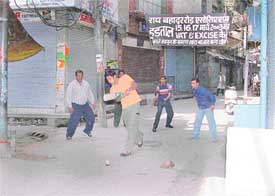 Striking traders while away their time playing cricket as Ludhiana hosiery markets remained closed in protest against the introduction of VAT